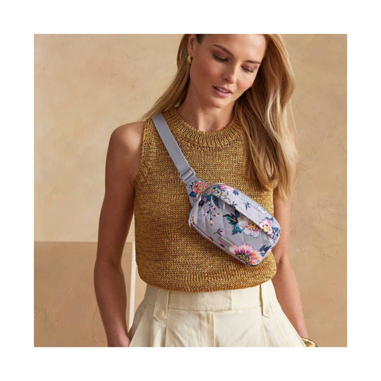 Floral mini belt bag with light gray strap, worn crossbody over a knit top