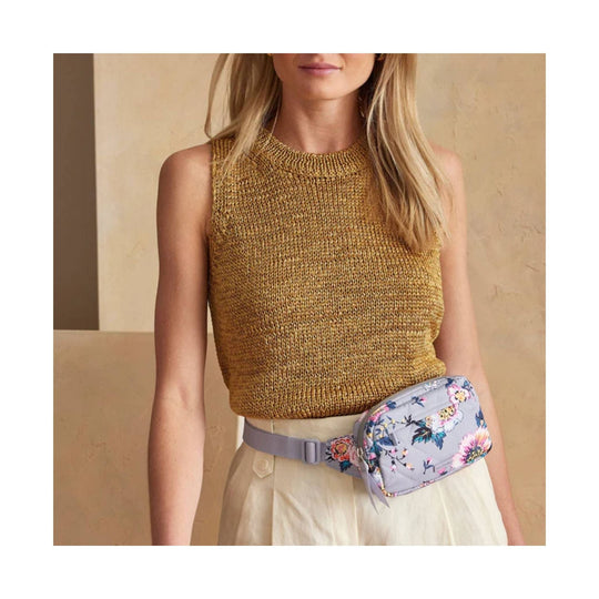 Light blue floral quilted belt bag worn at the waist with a lavender strap