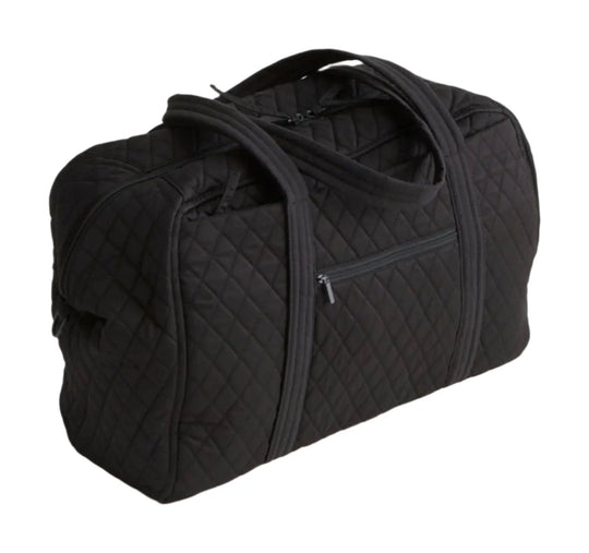 Black quilted duffel bag with top handles, zippered front pocket, and shoulder strap