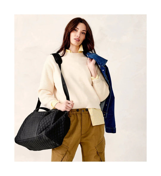 Black quilted weekender duffel bag with wide shoulder straps