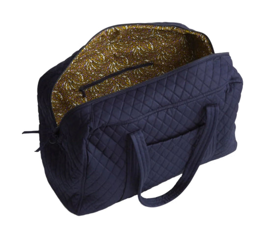 Quilted navy duffel bag with zip-top opening and patterned lining