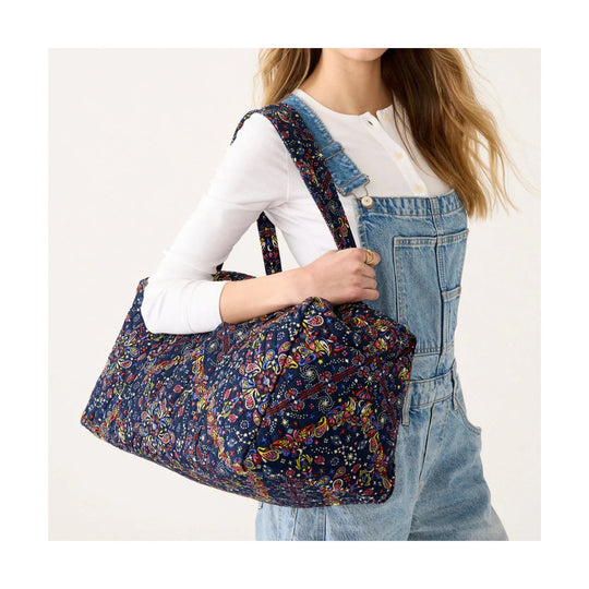 Blue floral duffel bag with dual handles and shoulder strap