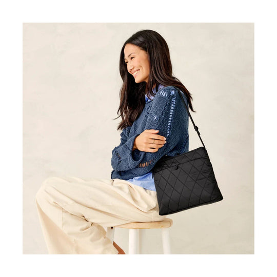 Black quilted shoulder bag with a long strap and diamond stitching
