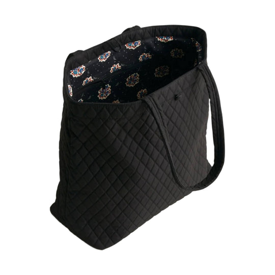 Black quilted tote bag with long shoulder straps and patterned fabric lining
