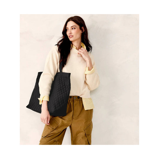 Black quilted tote bag with wide shoulder straps