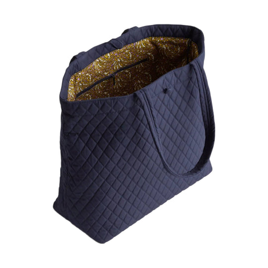 Quilted navy tote bag with floral patterned lining and open top