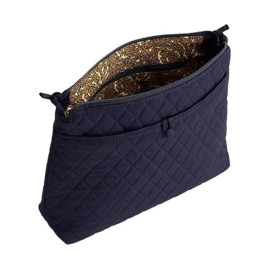 Quilted navy zip-top crossbody pouch with patterned floral lining and front pocket