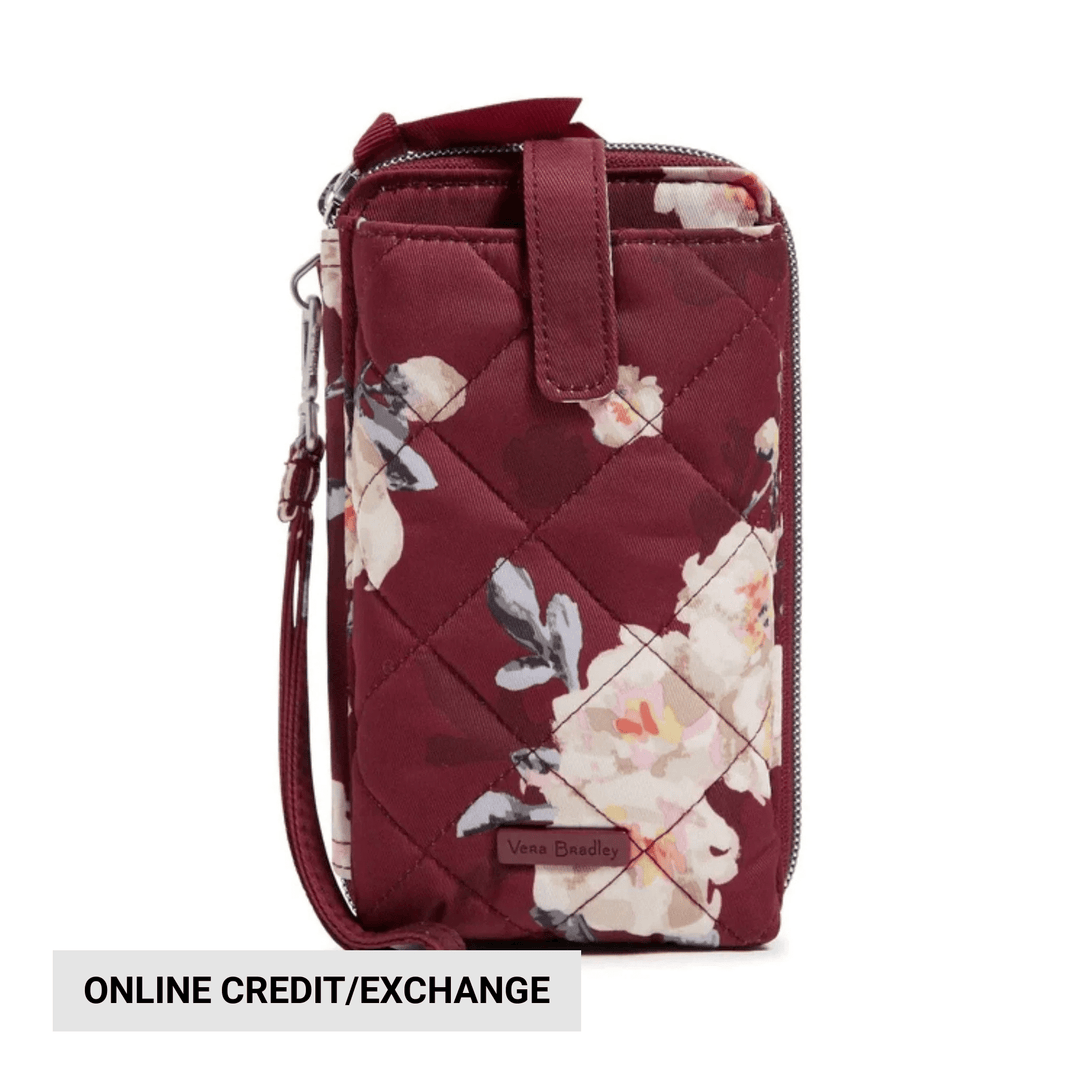 Burgundy quilted smartphone wristlet with floral print, zip closure, wrist strap, and visible "ONLINE CREDIT/EXCHANGE" text