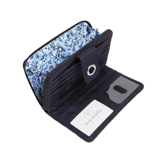 Open navy zip-around wallet with card slots, clear ID window, and floral blue lining