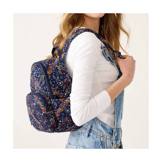 Navy patterned backpack with multiple zip pockets and top handle