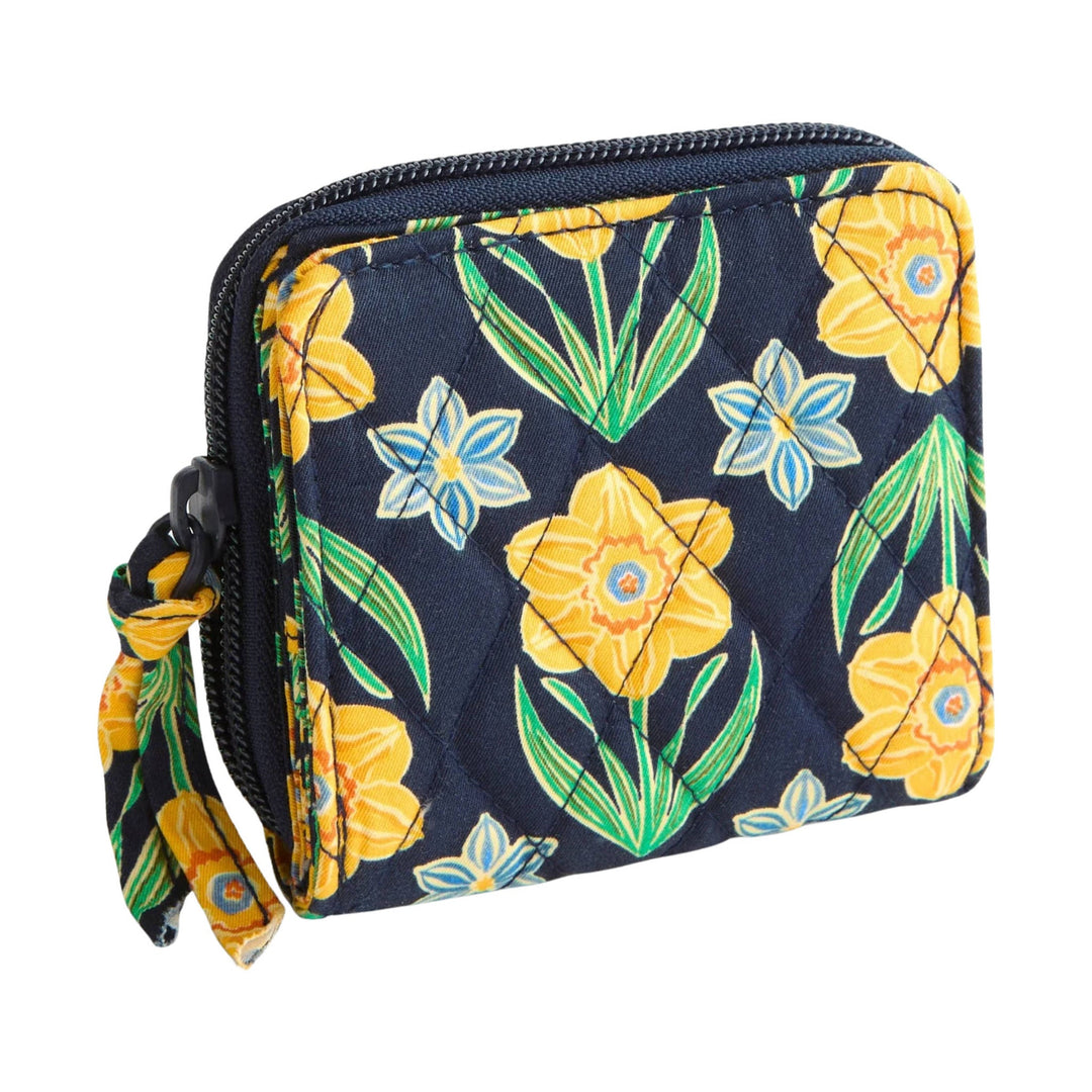 Small quilted floral zip-around wallet with navy background and wrist strap