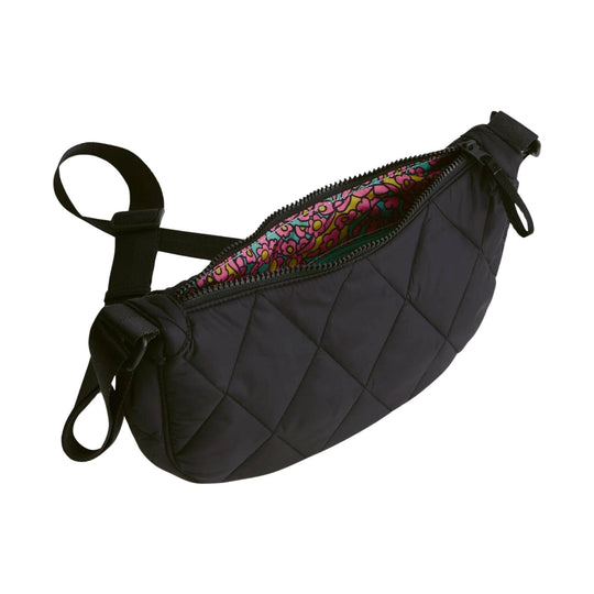 Black quilted sling crossbody bag with zipper closure and bright floral lining