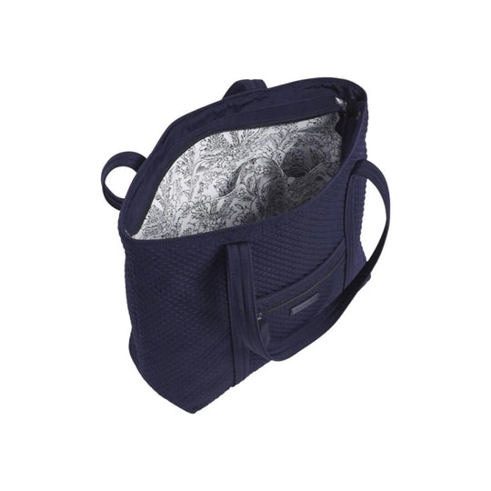 Navy quilted tote bag with zip top, dual handles, and white floral lining