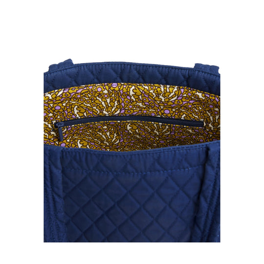 Quilted navy tote bag with a floral patterned interior and zip pocket