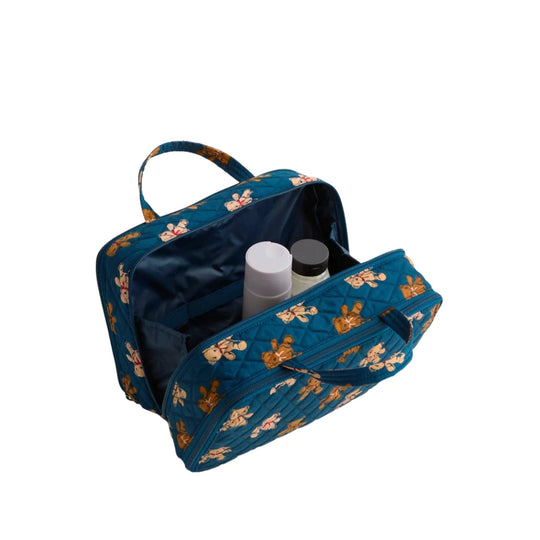Blue quilted zippered travel case with bear print, open to show interior pockets and two bottles inside