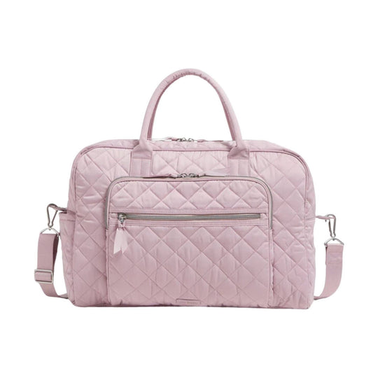 Light pink quilted weekender bag with top handles, detachable shoulder strap, and front zip pocket