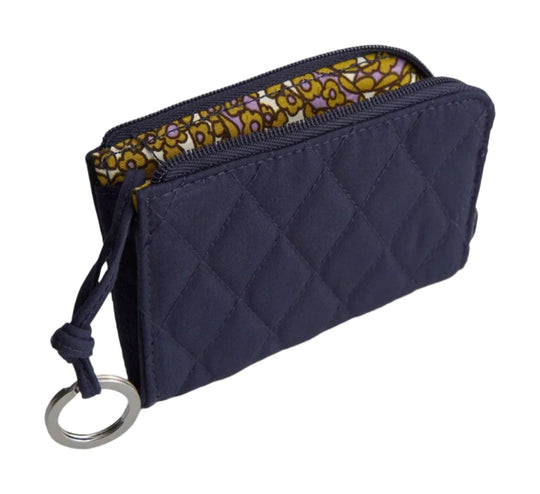 Navy quilted zip pouch with patterned lining and a metal key ring
