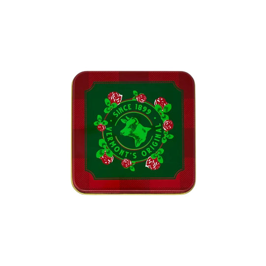 Red plaid square tin with a green label, cow logo, and floral wreath
