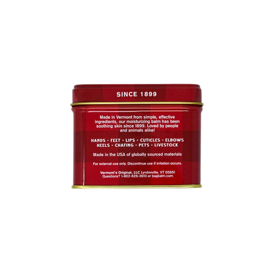 Red metal balm tin with gold rim and white text, showing the back label and “SINCE 1899”