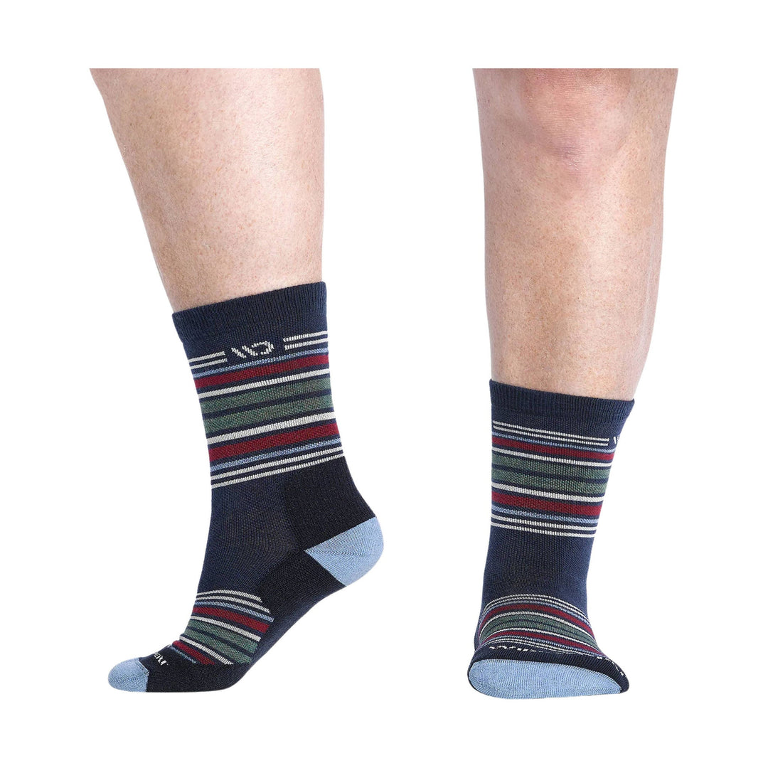 Pair of navy micro crew socks with multicolor stripes and light blue heel and toe accents, shown on legs from side and back views