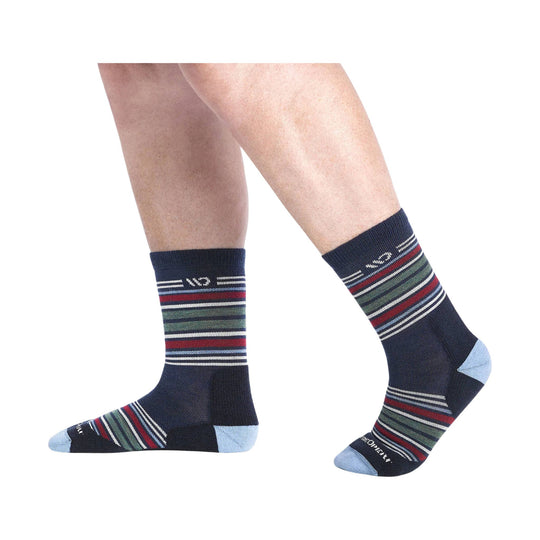 Navy crew socks with multicolor horizontal stripes and light blue toes and heels, shown on a model's legs.