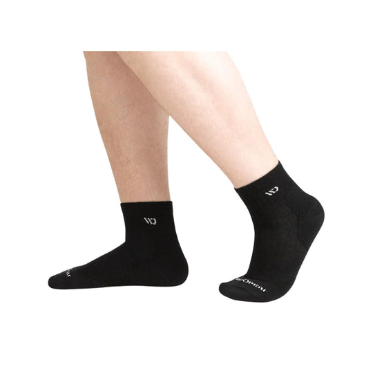 Black quarter socks worn on legs, with small white logo text near the ankle and toe.