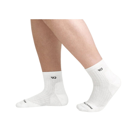 White ribbed quarter socks on a model's feet, with black logo text on the cuff and toe