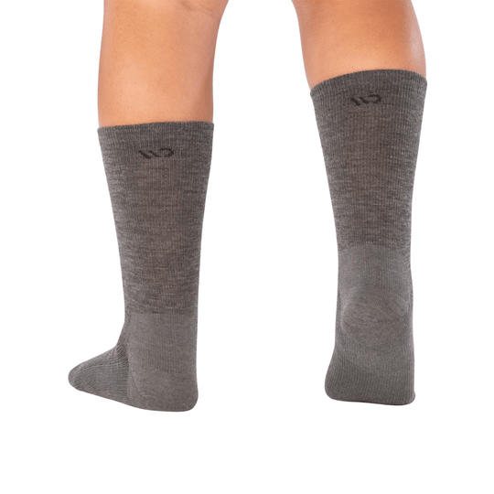 Gray crew socks with a small “wo” logo near the top, shown on model legs