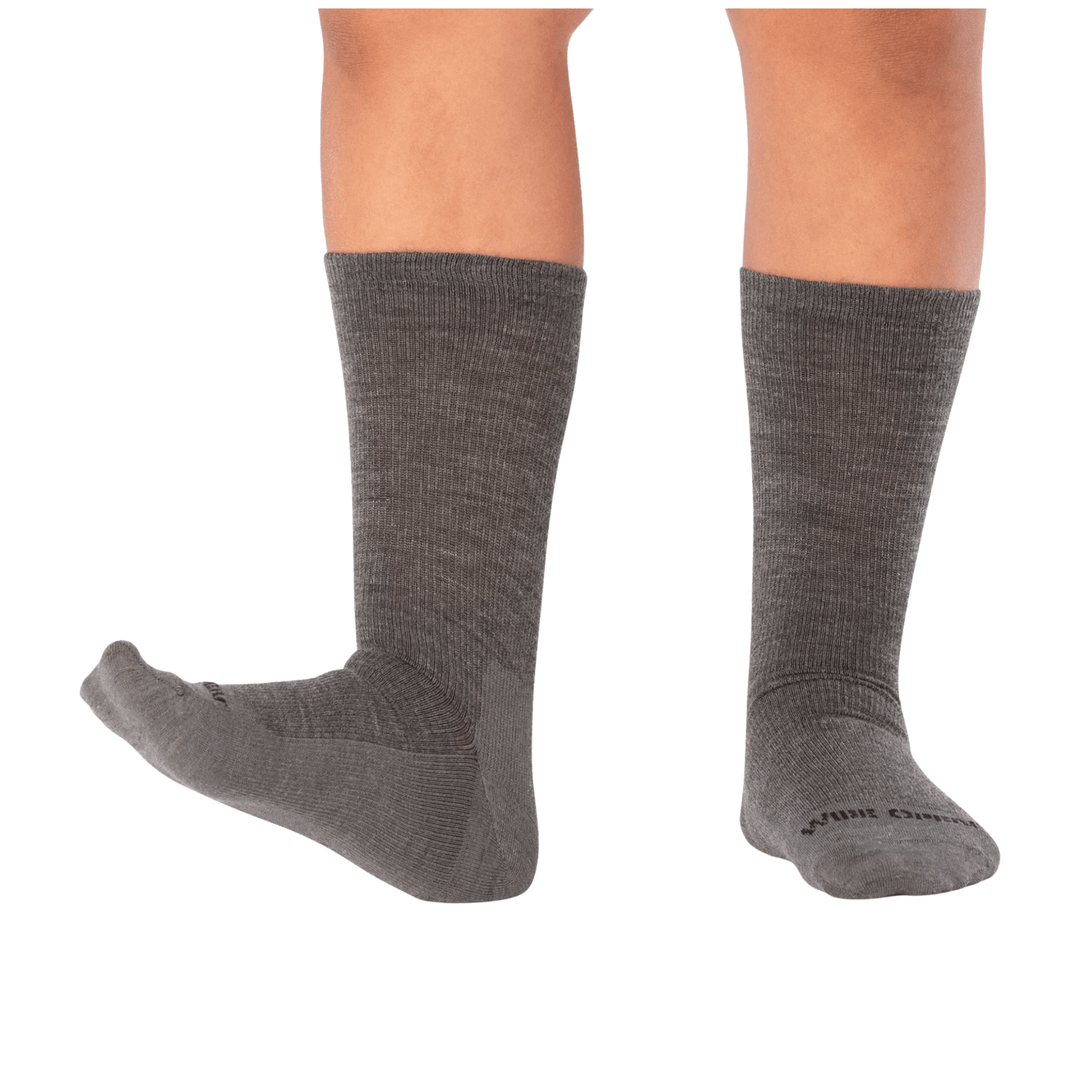 Gray knee-high crew socks shown on a model's lower legs, with one foot pointed and one foot facing forward