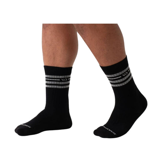 Black crew socks with gray and white striped cuffs on a model's legs