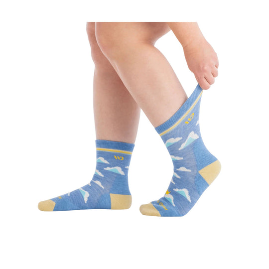 Blue crew socks with cloud pattern, yellow heel and toe, shown on a model's legs