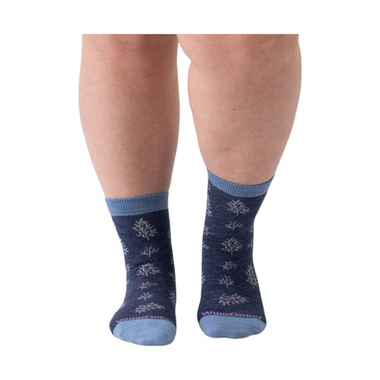 Navy patterned crew socks with light blue cuffs and toes on a model's lower legs
