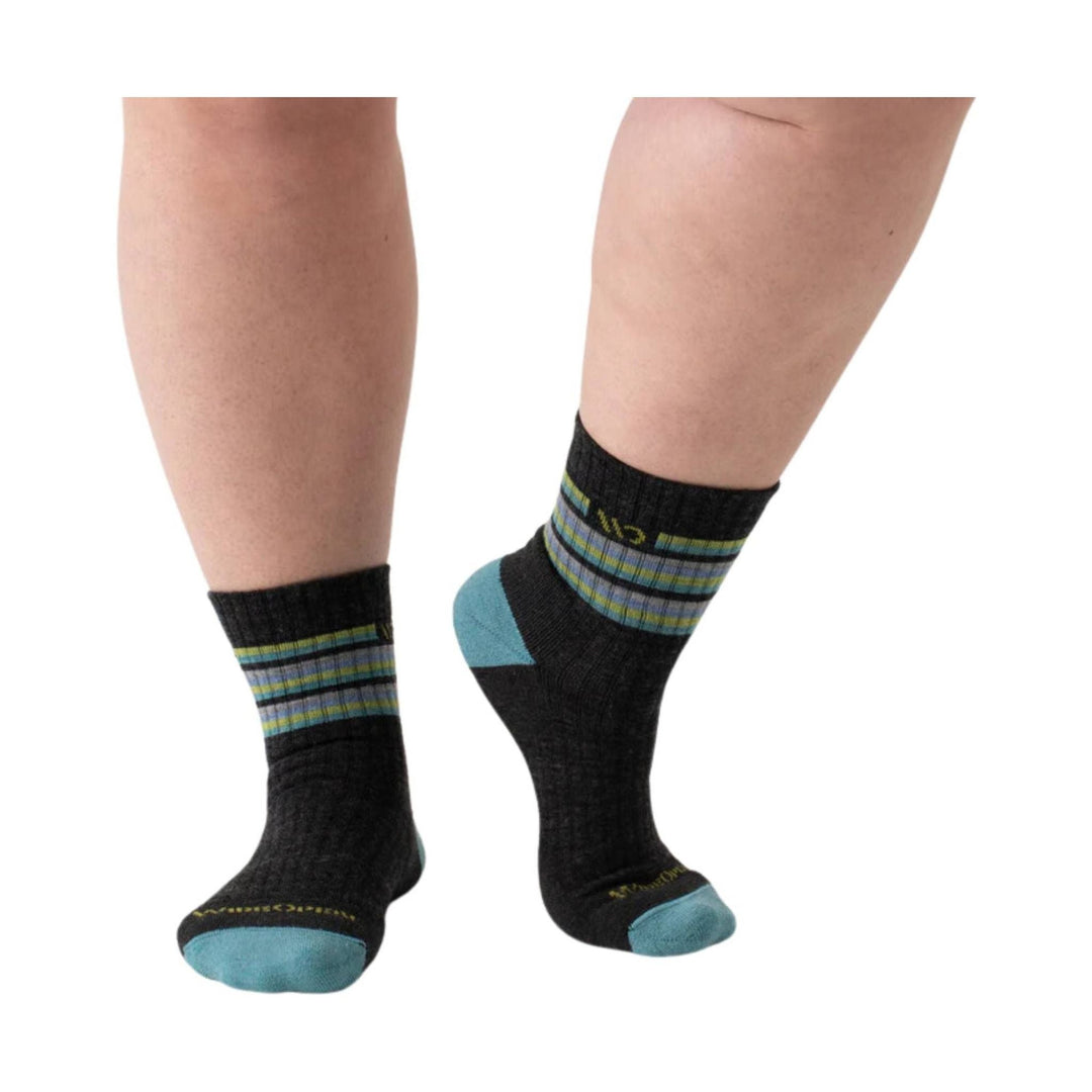 Black ankle socks with blue and green stripes, blue reinforced heels and toes, worn on legs.
