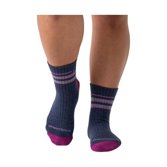 Pair of denim blue ankle socks with magenta toe and heel accents and multicolor stripes at the cuff