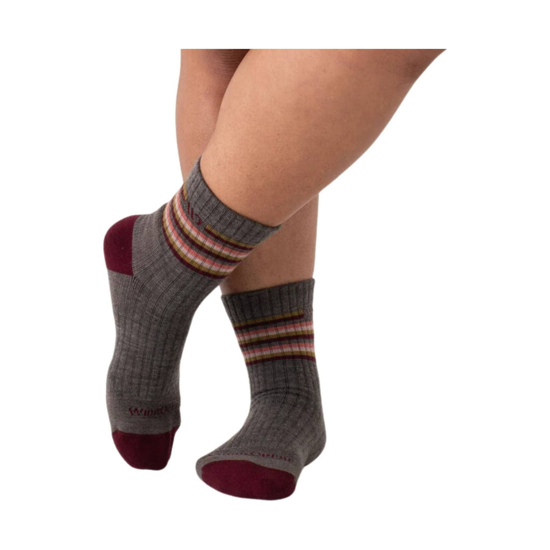 Gray ankle socks with burgundy heel and toe and multicolor striped cuffs on a model's feet