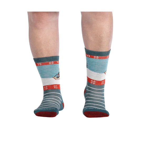 Pair of teal crew socks with red and white winter stripes and snowflake pattern