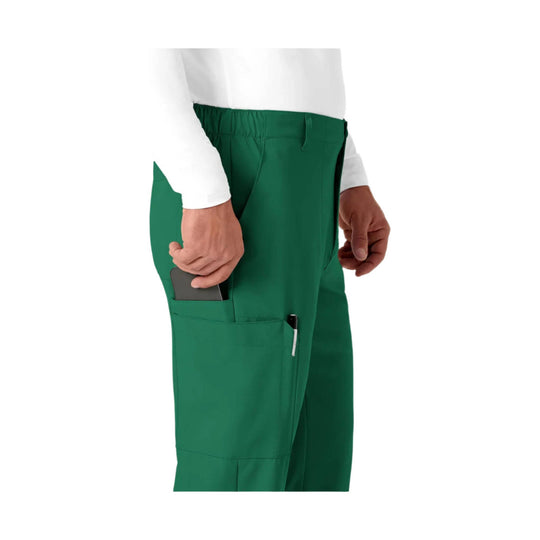 Green cargo scrub pants with side pocket and pen slot, shown on a model