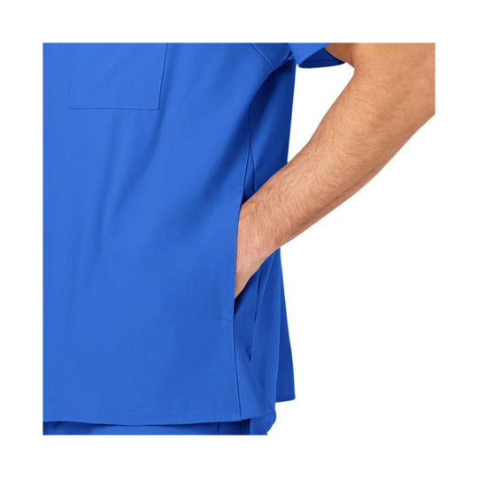 Side view of a blue scrub top with a chest pocket and a hand in the side pocket