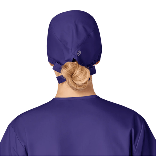Purple scrub cap shown from the back with an elastic tie and a low bun at the nape
