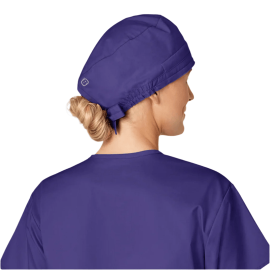 Purple scrub cap shown from the back on a model with hair tucked into a bun