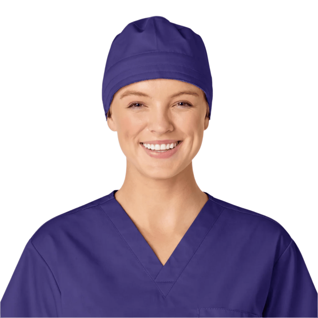 Purple scrub cap worn with matching purple scrubs on a smiling person against a white background