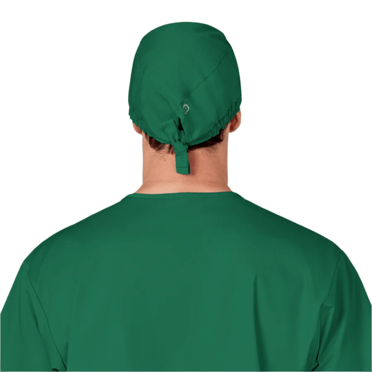 Green scrub cap worn on the back of a person’s head, shown from behind