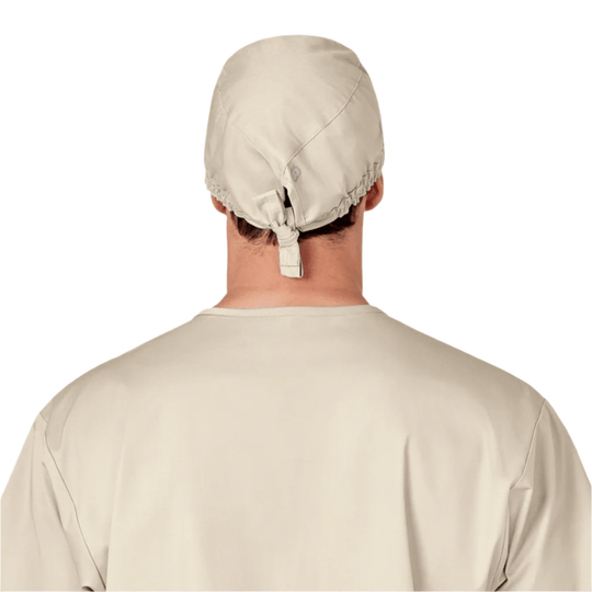Beige scrub cap shown from the back with an adjustable tie closure