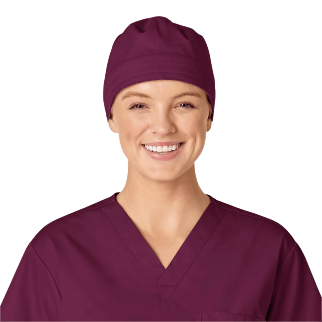 Burgundy scrub cap and V-neck scrub top on a smiling model