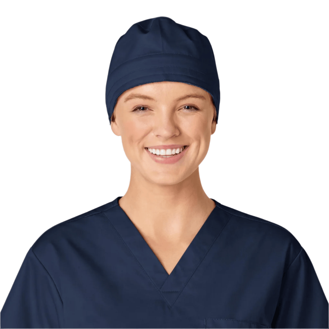 Navy scrub cap on a smiling person wearing navy scrubs