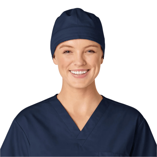 Navy scrub cap on a smiling person wearing navy scrubs