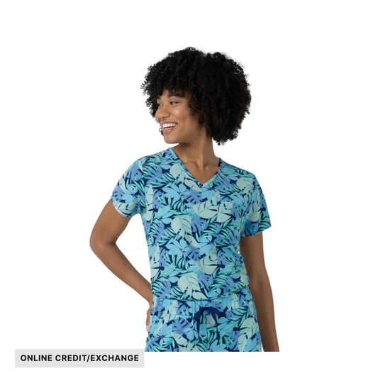 Blue tropical-print V-neck scrub top with short sleeves on a model, with "ONLINE CREDIT/EXCHANGE" text