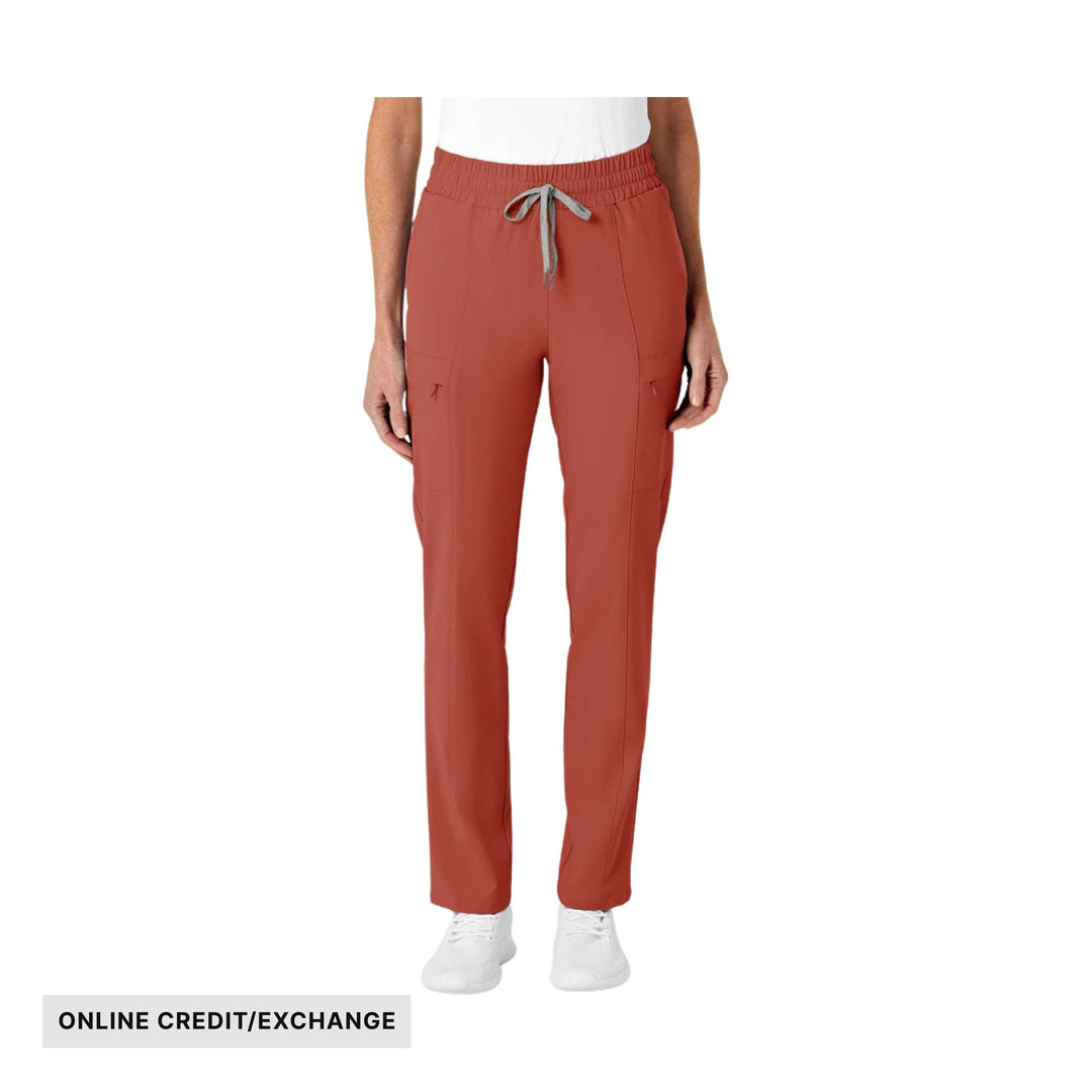 Rust-colored slim-leg scrub pants with elastic waistband, drawstring, and side pockets; "ONLINE CREDIT/EXCHANGE" text at bottom