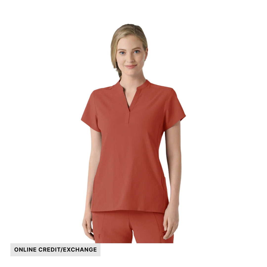 Woman wearing a rust-red short-sleeve scrub top with matching pants