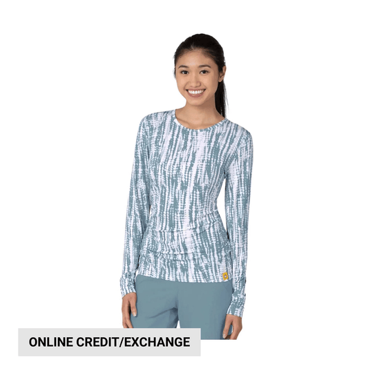Long-sleeve patterned women’s scrub top with crew neck and light blue pants